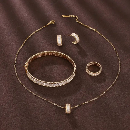 A Minimalist Four-Piece Jewelry Set for Women, Including a Ring, Earrings, Necklace, And Bracelet, Exuding a Sense of Elegance.